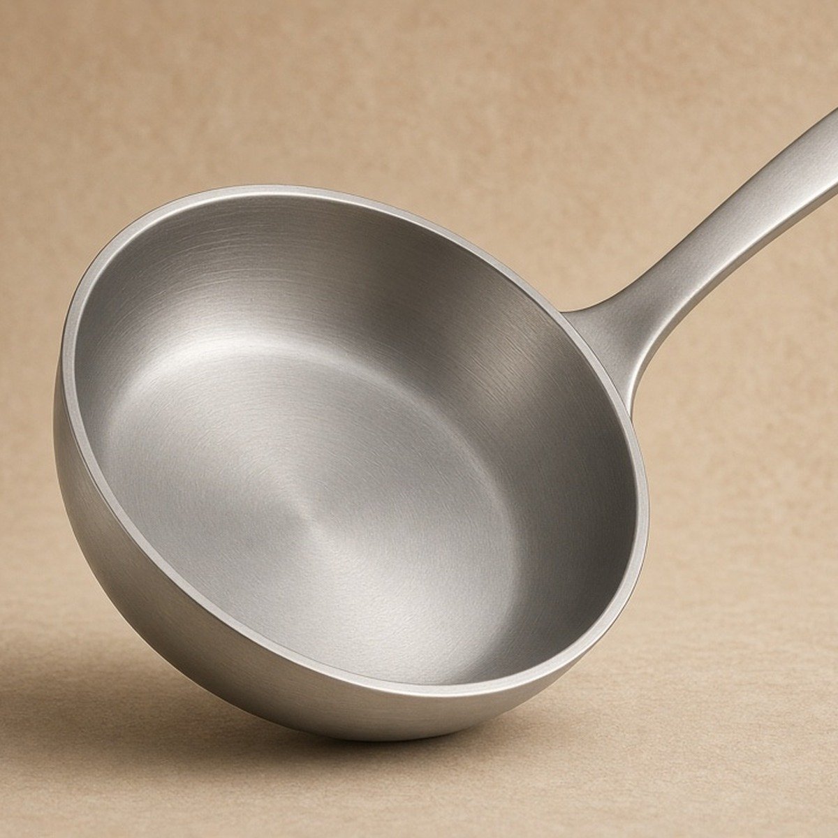 Skillet standing on edge — silhouette and handle length clear.
